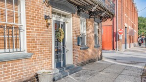 A brick building with a white door, a window with a metal grill, and a 'DO NOT ENTER' sign. - Location! Perfect Downtown Savannah Couples Getaway 1 bed 1 bath (Savannah)