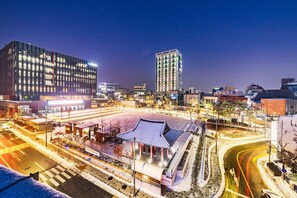 A modern urban area with a traditional building featuring a curved roof and a central pavilion. - Chuncheon Bella Residence Hotel (Chuncheon)