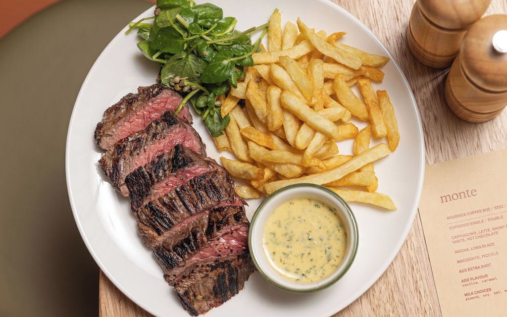 A plate with steak, fries, and a side salad.