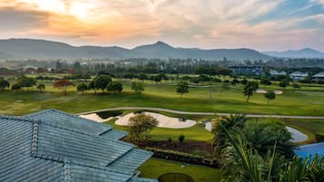 Enjoy a serene golf course view with rolling hills and a peaceful water feature.