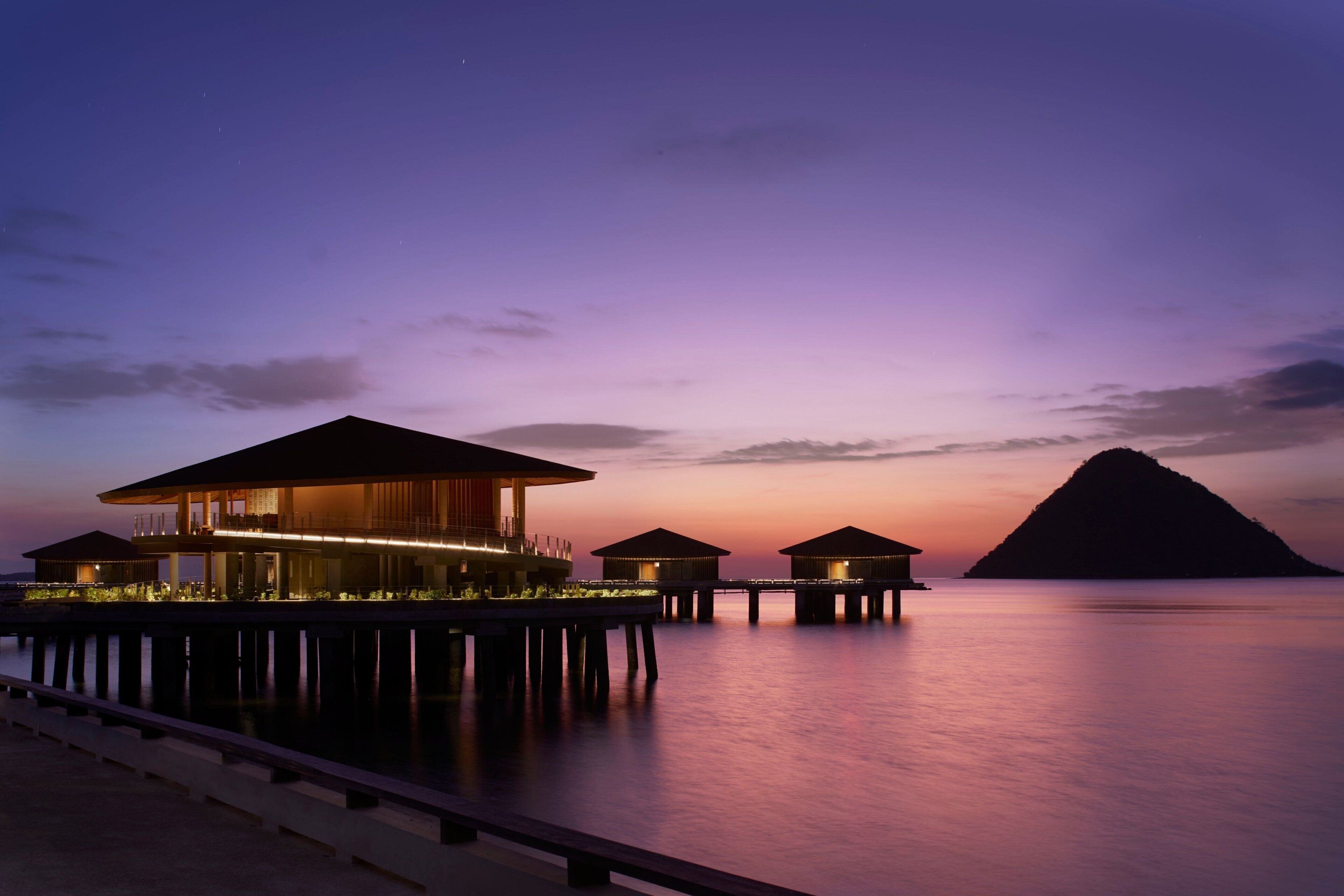 A waterfront resort with overwater bungalows connected by walkways.