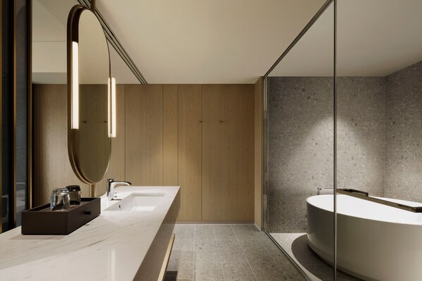 A modern bathroom with a large mirror, a wooden vanity, a freestanding bathtub, and a glass shower enclosure. - Nagasaki Marriott Hotel (Nagasaki)