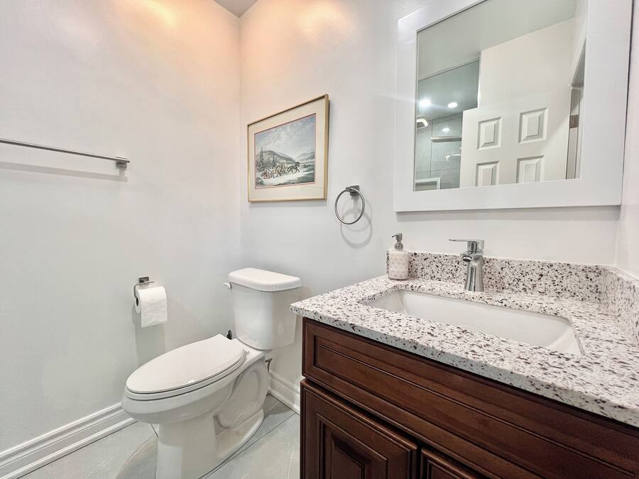Un baño moderno con inodoro, lavamanos y tocador.