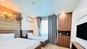 A hotel room with two beds, a TV, a wardrobe, and a bedside table. - Thu Do Vang Hotel Ha Dong By Bay Luxury (Hanoi)