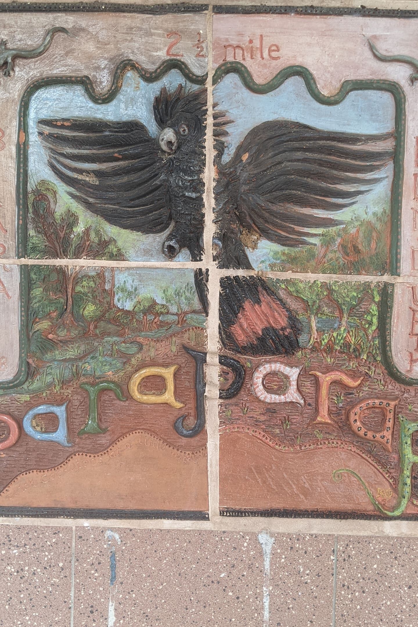 A mosaic with a bird and landscape.