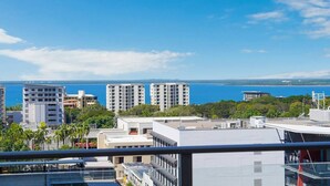 A coastal cityscape with high-rise buildings and a clear view of the ocean. - Harbour View Apartment on 11th floor | King Bed (Darwin City)