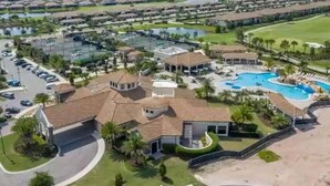 A large resort with multiple swimming pools, a golf course, and a well-maintained landscape.
