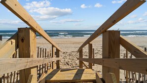 A wooden beach walkway leading to the ocean with a clear view of the sea and sky. - 7019- Sara's Sea Breeze - Oceanfront Rodanthe | Hot Tub | Sleeps 12 (Rodanthe)