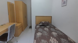 A small, neatly arranged bedroom with a single bed, a desk, and a chair. - Hotel O Kamboja Homestay Syariah (Medan)