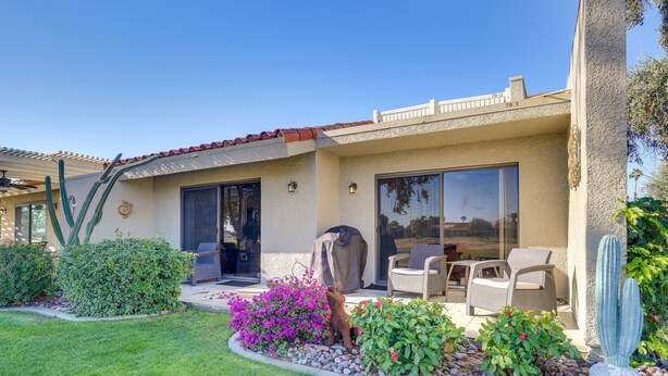 A house with a patio, outdoor furniture, and a cactus sculpture. - Palm Desert Condo w/ Patio & Golf Course Views! (Palm Desert)