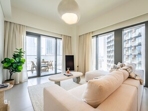 Deluxe Apartment | Living area | 42-inch Smart TV with cable channels - Lavishly Elegant 2BR with Breathtaking Burj View (Dubai)