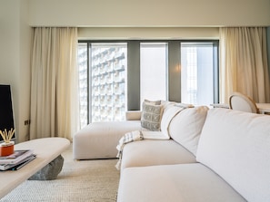 Deluxe Apartment | Living area | 42-inch Smart TV with cable channels - Lavishly Elegant 2BR with Breathtaking Burj View (Dubai)