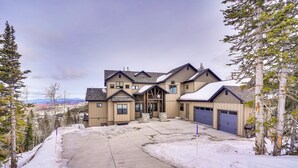 A large, multi-story house with a snow-covered driveway and surrounding trees. - Spacious Utah Escape w/ Balcony & Mountain Views! (Brian Head)