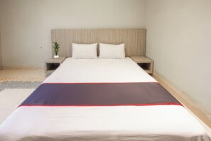 A neatly made bed with a white and dark-colored bedspread, two pillows, and a wooden headboard. - Hotel O Bale Jiwan Mukti Narmada Near SMA NW NARMADA (Narmada)