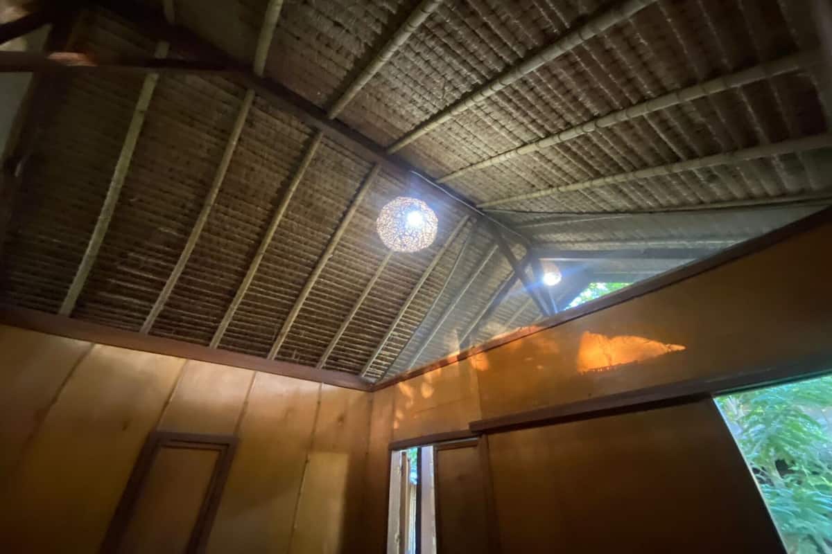 A room with a wooden ceiling and a circular light fixture.