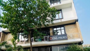 A two-story building with a sign reading "King Palace." - King Palace By GRB (Agra)