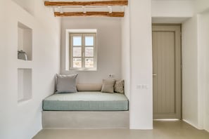 Superior Suite | Living area | 42-inch LED TV with cable channels, fireplace, Netflix - Lil Paros Luxury suites  (Paros)