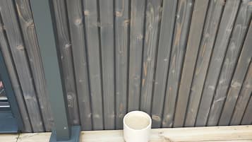 A wooden deck with a white bowl on it.