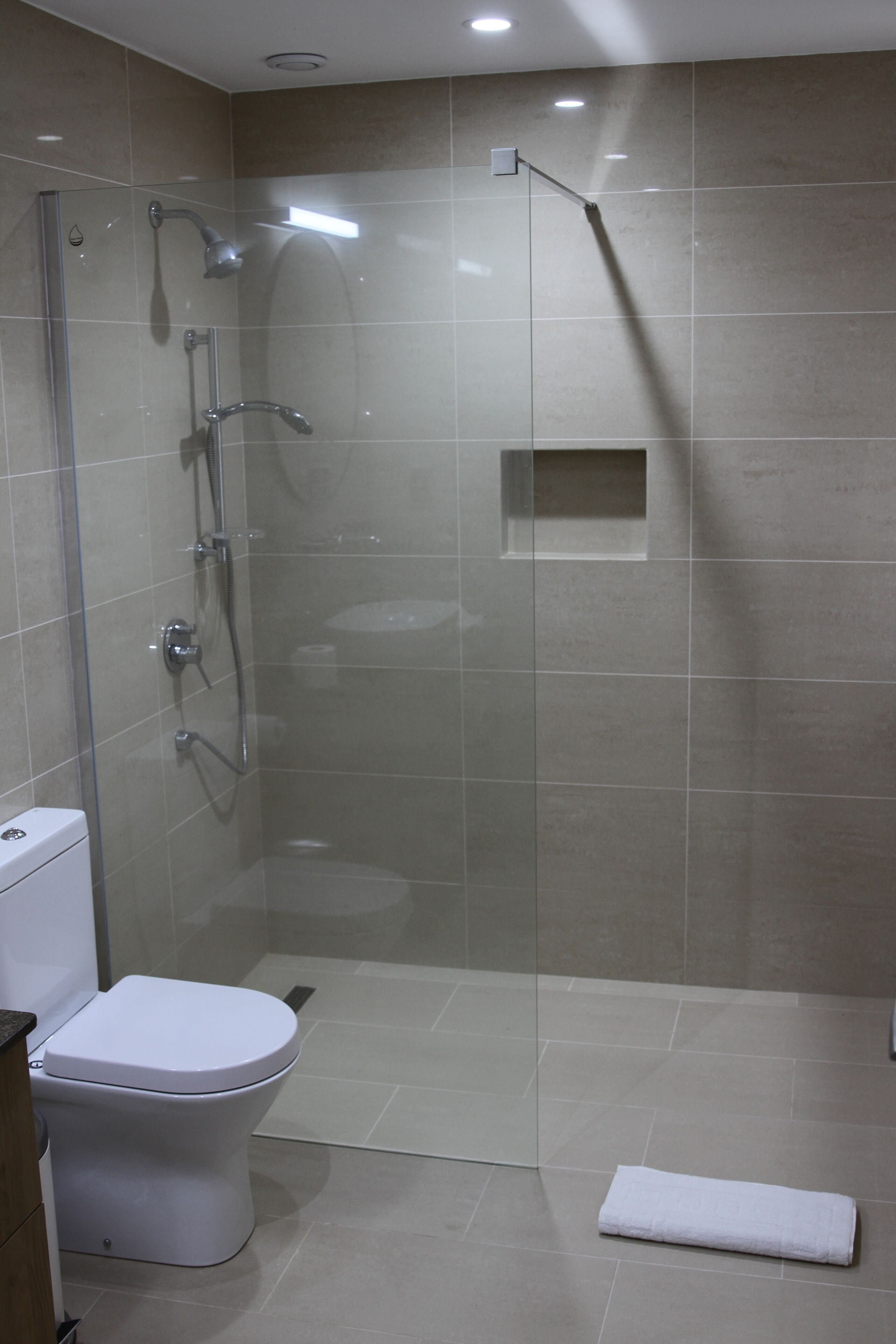 Shower, rainfall showerhead, hair dryer, towels