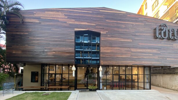 A modern building with a wooden facade, large glass windows, and a visible entrance. - CHERN CHIANGMAI BOUTIQUE (Chiang Mai)