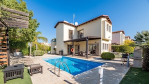 A two-story house with a swimming pool, outdoor seating, and a pergola. - Villa Artemis (Paralimni)