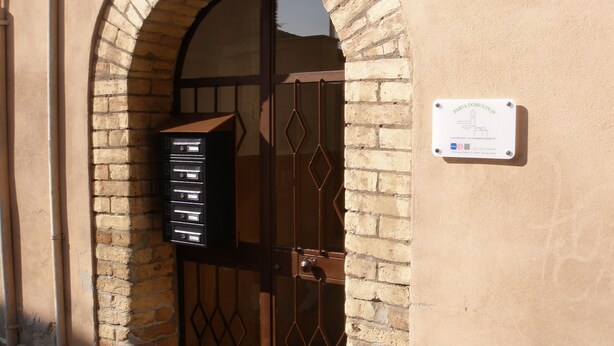 A building entrance with a metal gate and a mailbox. - Parva Domus in 29 (Morlupo)