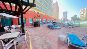 Relax in our tranquil courtyard, featuring sun loungers, dining tables, and a pool.