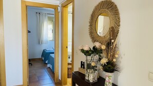 Habitación de hotel con cama, baño y pasillo que conduce a otra habitación.