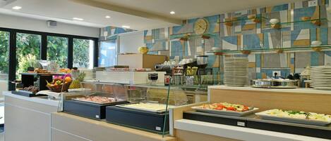 A buffet area with various food options, a clock on the wall, and a modern interior design.