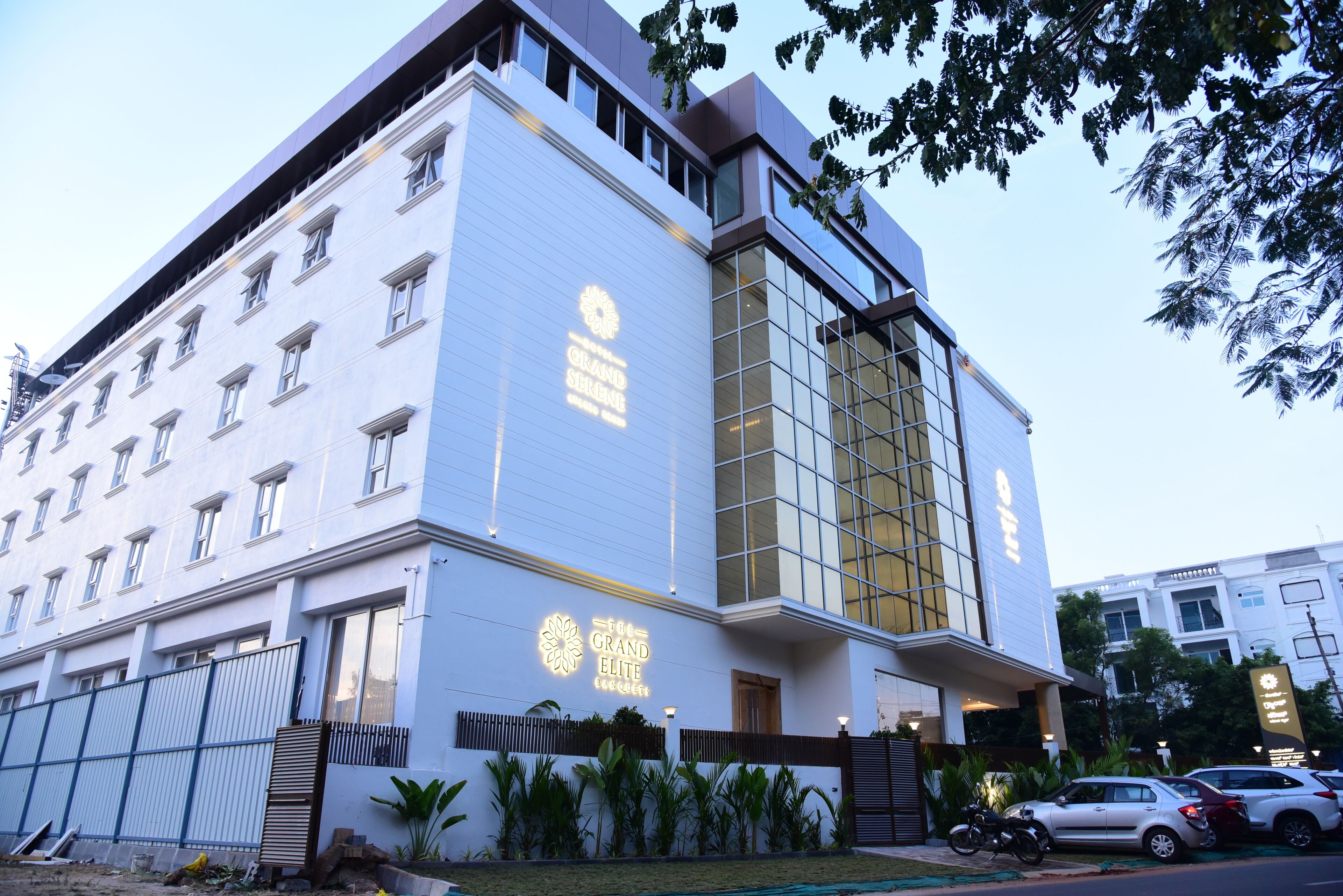 A modern building with a prominent sign reading "The Grand Elite."