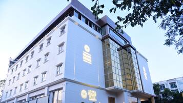 A modern hotel with a prominent sign reading "The Grand Elite."