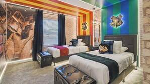 A hotel room with two beds, a large window with curtains, a brick wall, and a colorful striped ceiling. - Family 4BR Home w/ Pool at Storey Lake (Kissimmee)