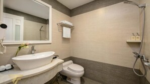 A modern bathroom with a freestanding sink, a toilet, and a shower. - Toan Thang Hotel by Bay Luxury (Hanoi)