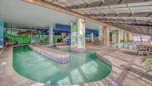 An indoor swimming pool with tiled steps and a mural. - 🏖️Large Oceanfront~Lazy River~Awesome Amenities~ Caribbean Resort 1807🏖️ (Myrtle Beach)
