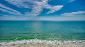 A beach with a clear sky and calm sea. - 🏖️Large Oceanfront~Lazy River~Awesome Amenities~ Caribbean Resort 1807🏖️ (Myrtle Beach)