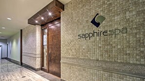 A hallway with a textured wall and a door labeled "sapphire spa". - Idyllic South Padre Island Condo: Walk to Beaches! (South Padre Island)