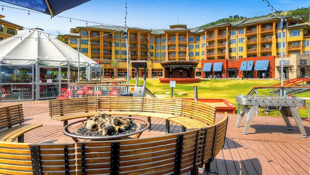 A hotel with a central courtyard featuring a fire pit, outdoor seating, and a pool table. - Ski-in/ski-out Park City Studio w/ Pool Access! (Park City)