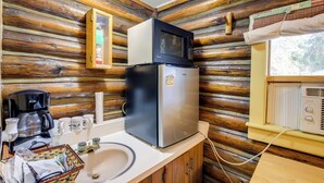 A compact kitchen with a refrigerator, microwave, coffee maker, and a sink. - Black Diamond Guest Ranch Cabin w/ Lodge Access! (De Borgia)