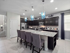 Fridge, microwave, oven, stovetop - Rebel Reef 8 BR Villa Themed Rooms, Pool,Arcade by Blue Sky Villas (Kissimmee)