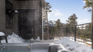 A hot tub area with snow accumulation, a wooden building, and a view of trees and mountains. - Incredible View, Open Floor Plan, Paved Roads, Hot Tub, Access to Clubhouse! (Lead)