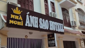 A hotel sign with "NHÀ SAO HOTEL" and a crown logo. - Anh Sao Hotel by Bay Luxury (Hanoi)