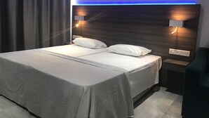 A modern hotel room with a large bed, two bedside lamps, and a headboard with built-in lighting. - Rio Gardens Aparthotel (Ayia Napa)