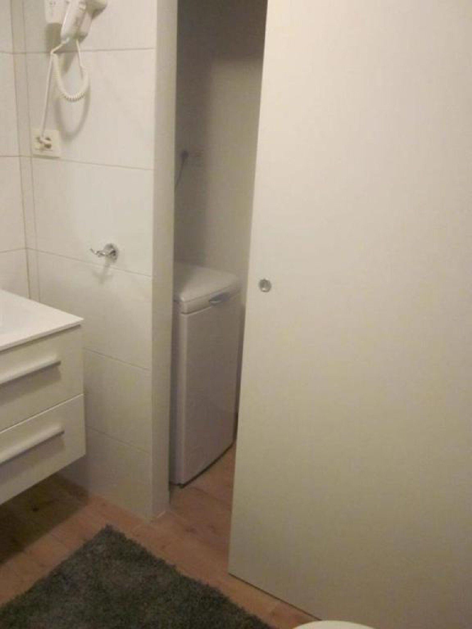 A bathroom with a toilet, a sink, and a shower.