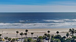A beach with palm trees and a clear blue sky. - San Luis Manor by Ryson Vacation Rentals (Galveston)