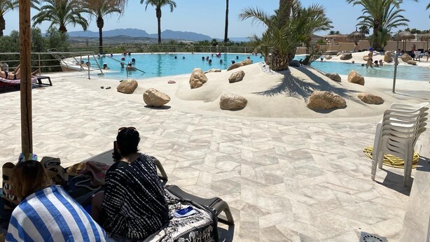 A pool area with large rocks, palm trees, and lounge chairs. - Comfortable & spacious Villa close from Leana Thermes- Clim & Private pool-  (Fortuna)
