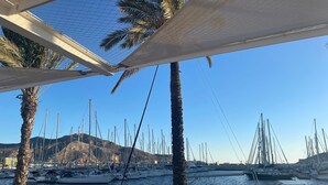 A marina with multiple sailboats docked, palm trees, and a clear sky. - Comfortable & spacious Villa close from Leana Thermes- Clim & Private pool-  (Fortuna)