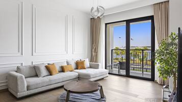 Deluxe Apartment | Living area | 55-inch Smart TV with cable channels, Netflix, streaming services