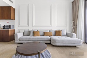 Deluxe Apartment | Living area | 55-inch Smart TV with cable channels, Netflix, streaming services