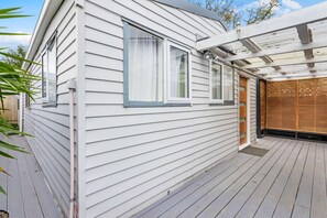 Contemporary home with a covered patio and wooden deck.