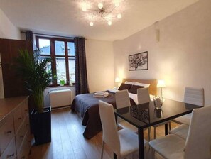 Relax in a stylish room with a comfortable bed, dining area, and a beautiful view.